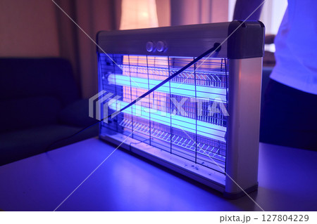 Operating a handheld UV light device specifically designed for killing insects effectively 127804229