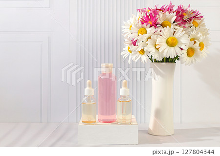 Wellness composition with cosmetic water and fresh flowers of garden chamomile and mallow, spa salon advertising card,natural self-care and healthy lifestyle concept, abstract composition with flowers Wellness composition with cosmetic water and fresh flowers of garden chamomile and mallow, spa salon advertising card,natural self-care and healthy lifestyle concept, abstract composition with flowers 127804344