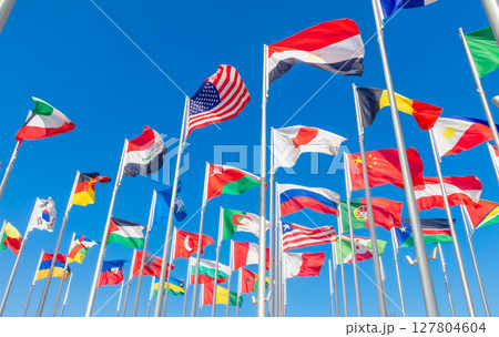 World congress countries national flags waving together on the wind, with American, Japanese, Omani, Chinese, Russian, Iraqi, Egyptian banners in the foreground, Doha, Qatar 127804604