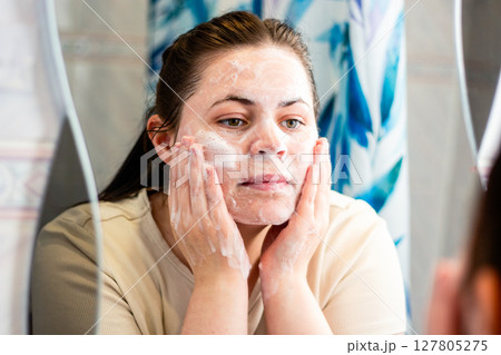 Morning skincare routine: woman doing first step of face skin cleansing routine. Relatable content for skincare. International self care day. Morning skincare routine: woman doing first step of face skin cleansing routine. Relatable content for skincare. International self care day. 127805275