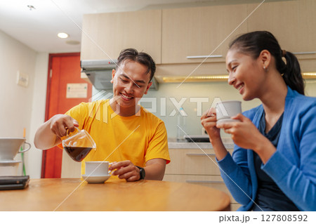 Enjoying a Cozy, Delightful Coffee Moment Together in a Modern, Inviting Kitchen Enjoying a Cozy, Delightful Coffee Moment Together in a Modern, Inviting Kitchen 127808592