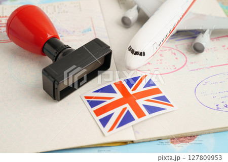 UK United Kingdom passport with approved stamp on document for tourism to immigration at airport in country. 127809953