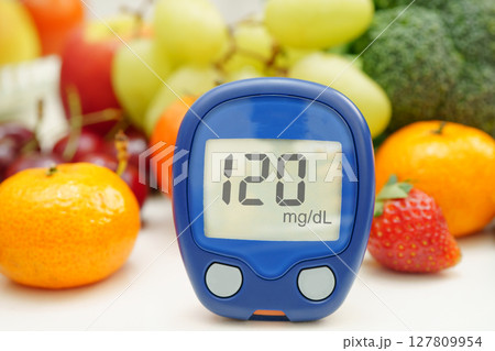Digital glucose meter for check sample blood sugar level to treatment diabetes with vegetable and fruit healthy. 127809954