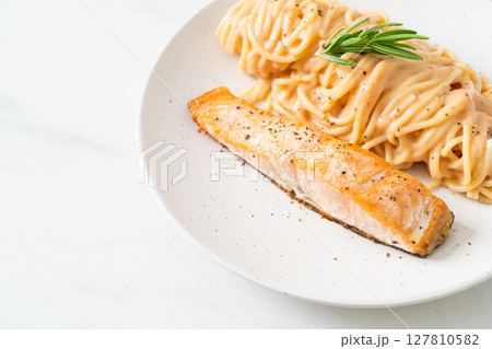 grilled salmon with spaghetti creamy tomato sauce grilled salmon with spaghetti creamy tomato sauce 127810582