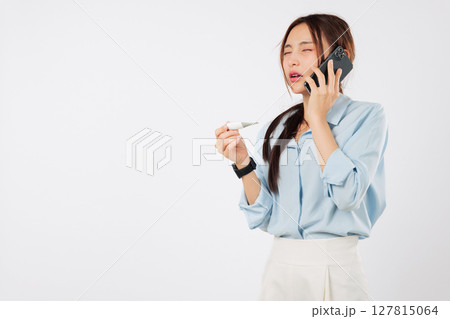 Asian woman feeling worried and sick talks on phone to her doctor about her disease and temperature while checking the thermometer making a call to discuss how sick she is, isolated white background Asian woman feeling worried and sick talks on phone to her doctor about her disease and temperature while checking the thermometer making a call to discuss how sick she is, isolated white background 127815064