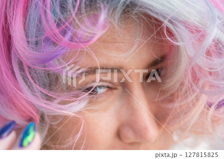 Close-up portrait of Caucasian woman with multi-colored hairstyle.  127815825