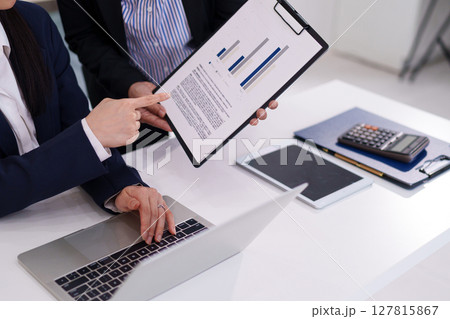 Asian Women Collaborate on Business Strategy Reviewing Market Data Charts for Growth Opportunity and Success with Financial Analysis Tools 127815867