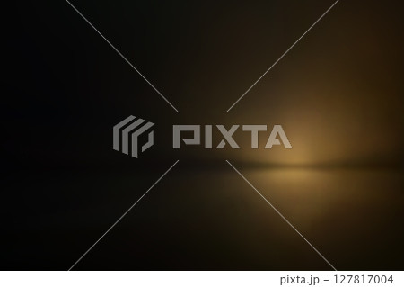 Soft golden haze in dark cinematic studio light 127817004