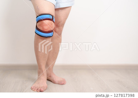 Elderly woman having knee ache with knee support brace for concepts of Runners Knee or Patellofemoral Pain Syndrome, osteoarthritis, arthritis, rheumatism and Patellar Tendinitis. Senior health care Elderly woman having knee ache with knee support brace for concepts of Runners Knee or Patellofemoral Pain Syndrome, osteoarthritis, arthritis, rheumatism and Patellar Tendinitis. Senior health care 127817398