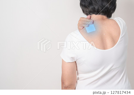 Elderly Woman having Shoulder Pain with Medicated pain relief patch plaster for Muscle Inflammation and Sprain, Myofascial ache syndrome and Fibromyalgia, Shoulder Myalgia and Scapular Tightness Elderly Woman having Shoulder Pain with Medicated pain relief patch plaster for Muscle Inflammation and Sprain, Myofascial ache syndrome and Fibromyalgia, Shoulder Myalgia and Scapular Tightness 127817434