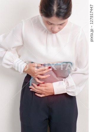Menstruation period cycle of monthly and Stomachache concepts. woman having abdomen pain and menstrual ache with hot water bottle, illness female suffer from premenstrual ache and body Health problem Menstruation period cycle of monthly and Stomachache concepts. woman having abdomen pain and menstrual ache with hot water bottle, illness female suffer from premenstrual ache and body Health problem 127817447