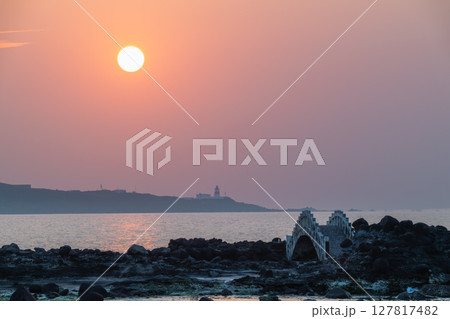 Sunset Glow Over Shimen Coastline and Fuguijiao Lighthouse New Taipei City. 127817482