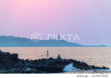 Photographer Captures Shimen Sunset with Fuguijiao Lighthouse New Taipei City. 127817483