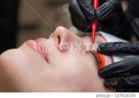 Caucasian woman undergoing eyelash lamination procedure. Caucasian woman undergoing eyelash lamination procedure. 127818150