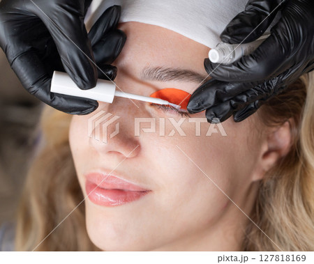 Caucasian woman undergoing eyelash lamination procedure. Caucasian woman undergoing eyelash lamination procedure. 127818169