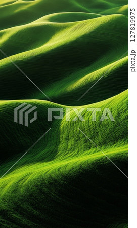 Rolling green hills create abstract patterns in the palouse region of washington state, illuminated by the warm glow of the setting sun, showcasing the beauty of nature and sustainable agriculture 127819975