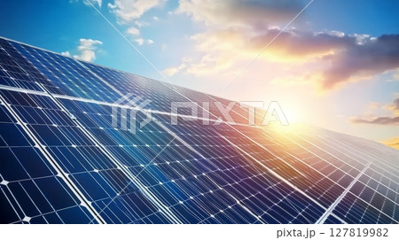 Solar panels are capturing the last rays of sunlight at sunset, generating clean and sustainable energy for a greener future, under a vibrant sky 127819982