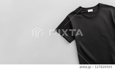Stylish black t shirt mockup with blank label lying on gray background, perfect for showcasing designs and logos, offering excellent space for customization and branding Stylish black t shirt mockup with blank label lying on gray background, perfect for showcasing designs and logos, offering excellent space for customization and branding 127820503