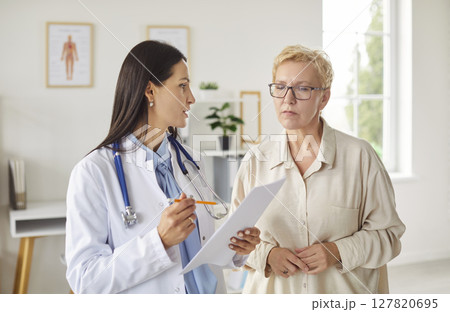 Doctor discussing medical test results with female patient in office and explaining treatment plan. Doctor discussing medical test results with female patient in office and explaining treatment plan. 127820695