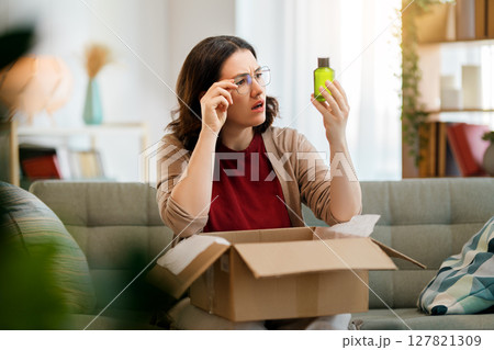Woman is unpacking cardboard 127821309