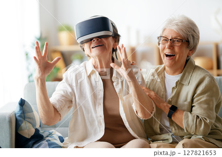 women playing console games wearing vr goggles women playing console games wearing vr goggles 127821653