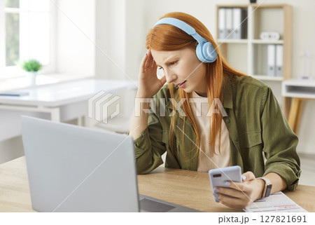 Upset Woman Working From Home, Reacting To Bad News On Her Phone Upset Woman Working From Home, Reacting To Bad News On Her Phone 127821691
