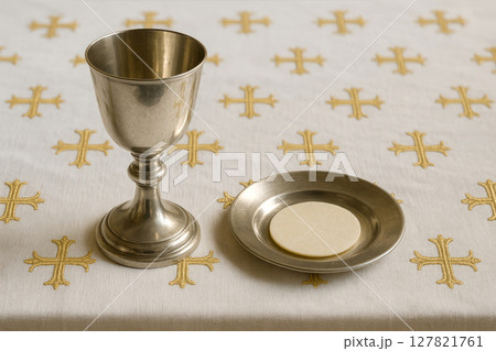 Silver chalice and communion wafer. Religious ceremony 127821761