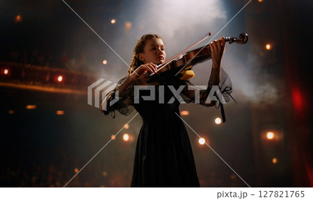 girl playing violin on stage girl playing violin on stage 127821765