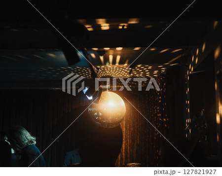 Disco Ball Reflections in a Room Dimly Lit, Exuding a Unique and Fun Atmosphere to Enjoy 127821927