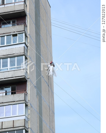 A Creative Climber Engaged in Working on a Highrise Building in an Urban Environment A Creative Climber Engaged in Working on a Highrise Building in an Urban Environment 127822013