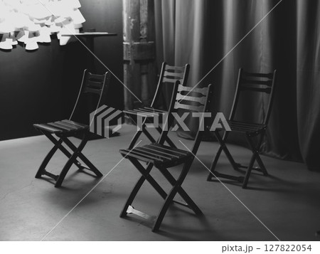 A minimalistic setup of black chairs beautifully arranged in a studio environment setting 127822054