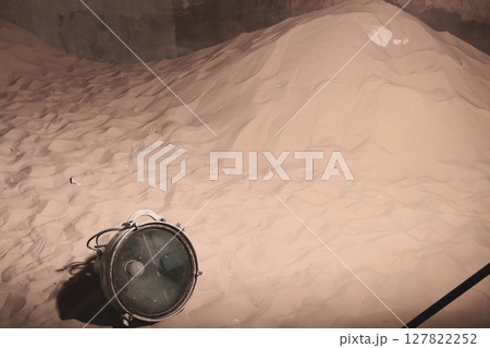 An Abandoned Industrial Scene featuring Sand, Various Equipment, and Unique Elements Present An Abandoned Industrial Scene featuring Sand, Various Equipment, and Unique Elements Present 127822252