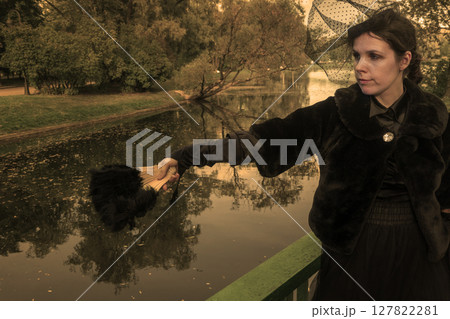 A women in vintage clothes on a walk in the park. A women in vintage clothes on a walk in the park. 127822281