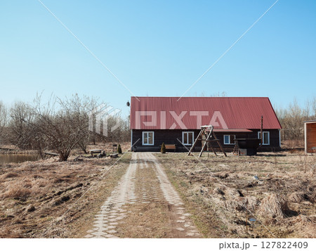 Charming Rustic House with a Distinctive Red Roof Surrounded by a Scenic and Picturesque Landscape 127822409