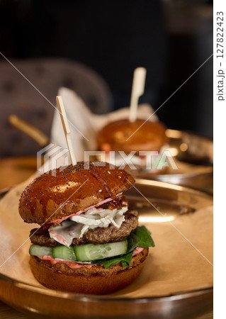 A Gourmet Burger Crafted with the Freshest Ingredients, Beautifully Served on a Platter 127822423