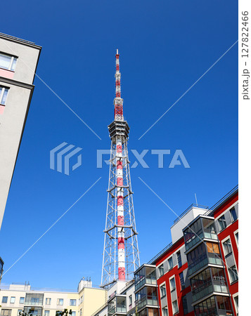 A striking Urban Communication Tower stands tall against a clear blue sky during daylight hours A striking Urban Communication Tower stands tall against a clear blue sky during daylight hours 127822466