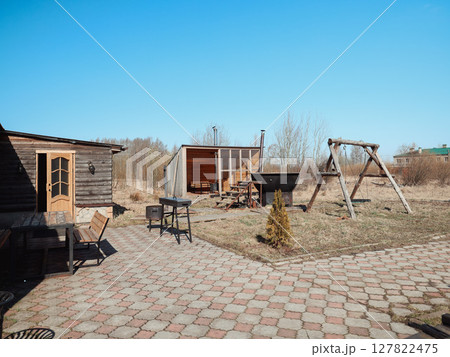 A Charming Outdoor Space Featuring Rustic Structures and a Clear Beautiful Sky Above 127822475