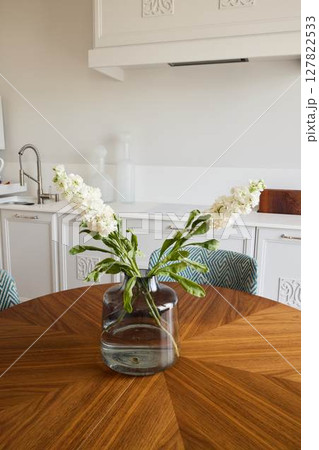 An Elegant Floral Arrangement Displayed Beautifully on a Modern Wooden Table Setting 127822533