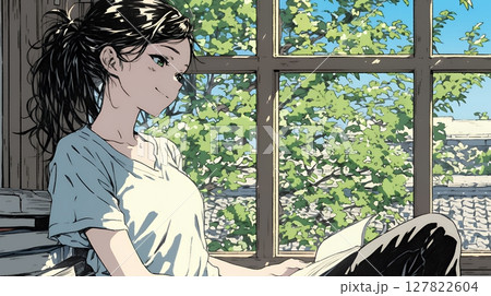 のんびり・ゆったり：窓辺でリラックスして本を読んでいる若い女性