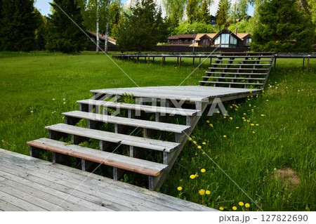 A Beautiful Set of Wooden Steps Nestled in a Peaceful and Serene Green Landscape 127822690