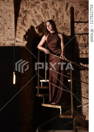 An Elegant Fashion Pose Captured in a Rustic Space with Great Artistic Flair and Style 127822758