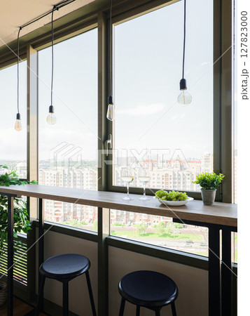 Elegant and Modern Urban Kitchen Featuring a Gorgeous Scenic City View with Stylish Bar Seating 127823000