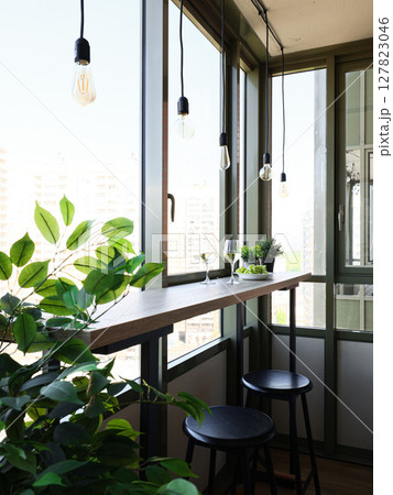 A Chic Modern Balcony with Stunning Greenery and Natural Light for Comfort and Style A Chic Modern Balcony with Stunning Greenery and Natural Light for Comfort and Style 127823046