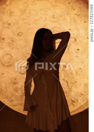 Silhouette Artistically Captured in Motion Against a Beautiful Lunar Backdrop at Night Silhouette Artistically Captured in Motion Against a Beautiful Lunar Backdrop at Night 127823169