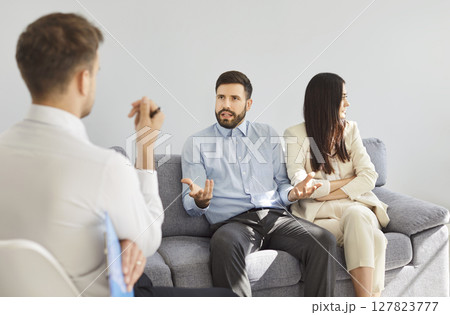 Psychologist Counseling Quarreling Couple During Therapy Session Psychologist Counseling Quarreling Couple During Therapy Session 127823777