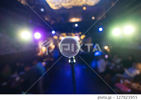 Microphone on stage against a background of auditorium. 127823955