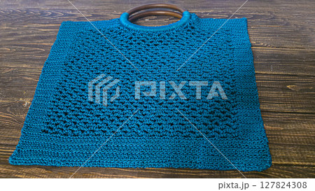 Knitting a product from a cord with a crochet hook. Step-by-step instructions 127824308