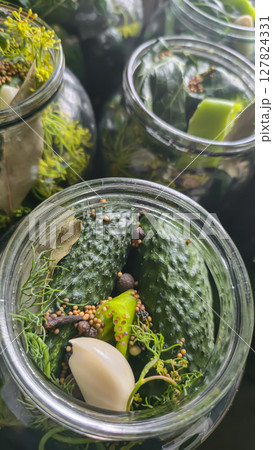 Jars with cucumbers and spices for preservation. Fermentation of cucumbers, 127824331