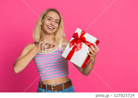 Happy smiling woman stretches out hands presenting birthday gift box promotion holiday discount sale 127825724