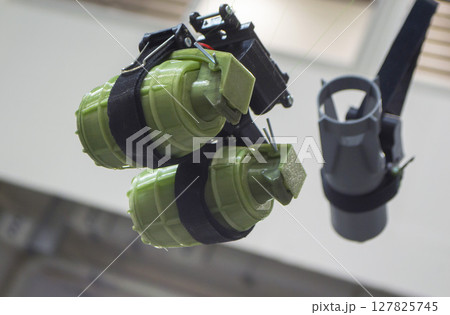 Hanging grenade. Grenade printed on 3D printer from melted plastic. Plastic grenade created on 3D printer. Prototype of ammunition printed on 3D printer. Innovation 3d printing. Innovation technology 127825745